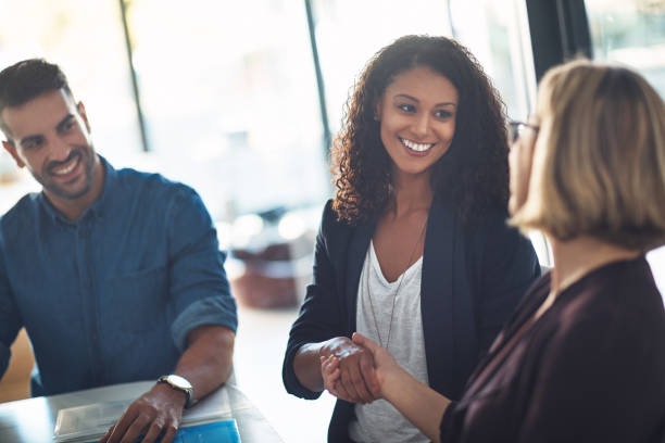 Happy to have you on the team Shot of two businesswomen shaking hands during a meeting in a modern office business relationship stock pictures, royalty-free photos & images