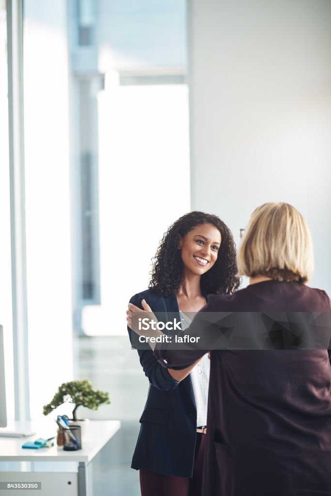 Very happy to be working with you Shot of two businesswomen shaking hands in a modern office Business Stock Photo