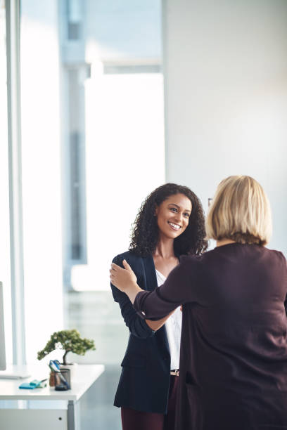 Very happy to be working with you Shot of two businesswomen shaking hands in a modern office employee introduction stock pictures, royalty-free photos & images