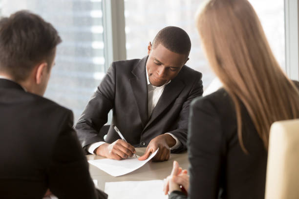 istock African american man singing employment agreement 843534128