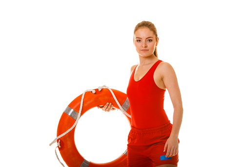 Lifeguard with ring buoy lifebuoy. Woman supervising swimming pool water. Accident prevention.
