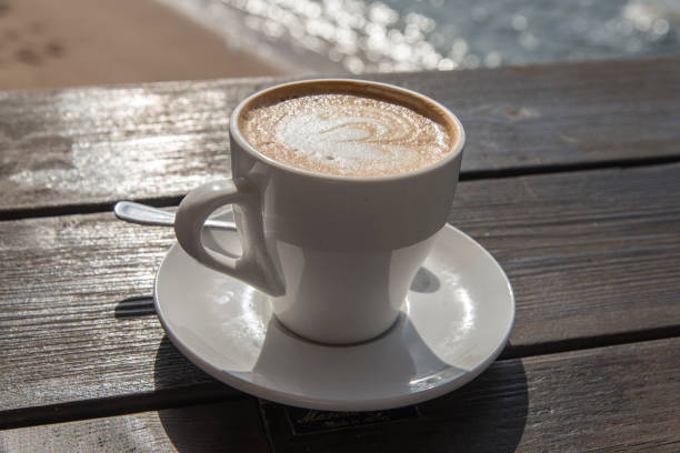 istock Cup of coffee on sea background 843538448