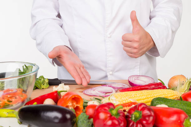 istock chef in jacket cooking fresh vegetables 843541540