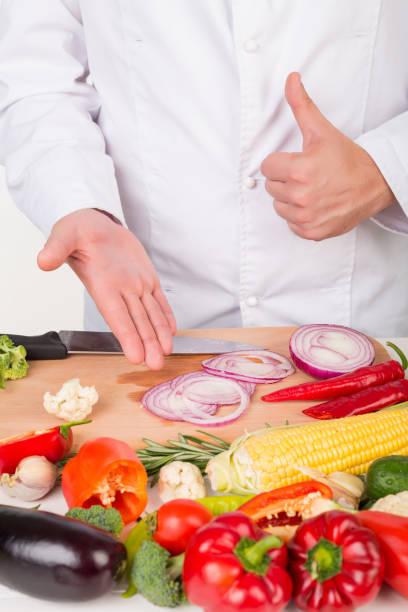istock chef in jacket cooking fresh vegetables 843541558