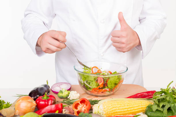 istock chef in jacket cooking fresh vegetables 843541566