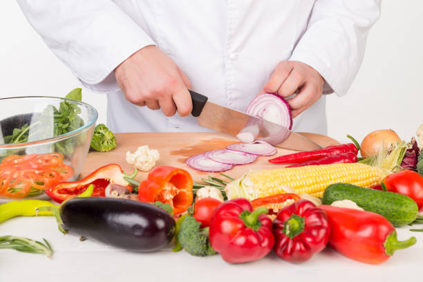 istock chef in jacket cooking fresh vegetables 843541586
