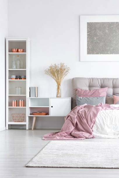 istock Bed with pastel pink quilt 843542756