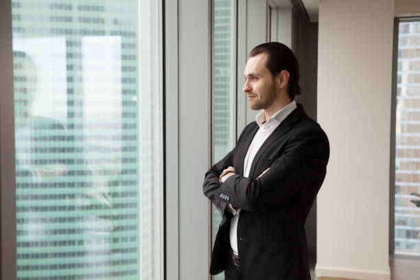 istock Successful young handsome businessman standing in the modern office 843545152