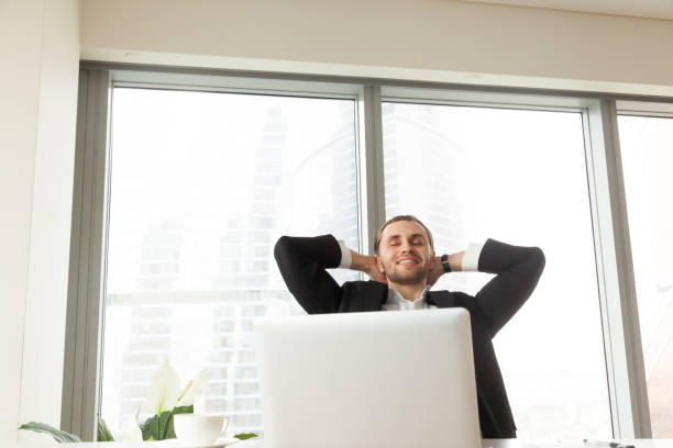 istock Happy businessman relaxing at workplace in modern office. 843545352