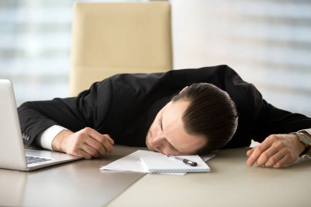 istock Exhausted businessman passed out at his work desk in office 843545516