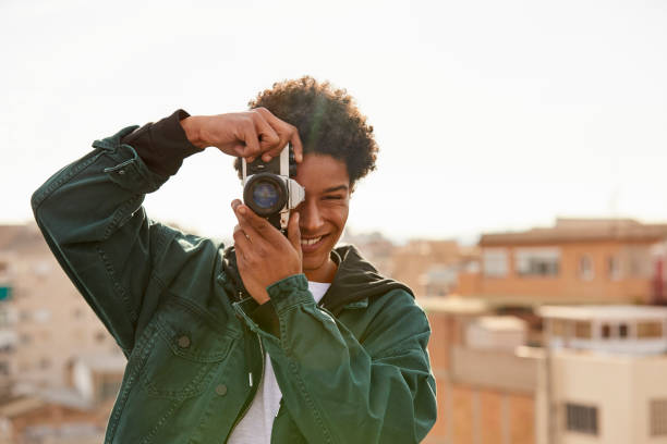 istock Smiling man photographing at rooftop 843548492