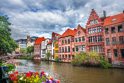 A general view of the historic and touristic city of Bruges in Belgium in summer from the Spiegelrei Canal and Jan Van Eyck Square with historic houses.