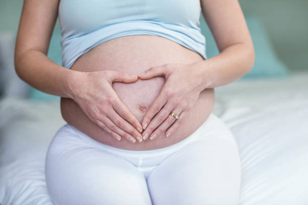 istock Pregnant woman touching her belly 843549894