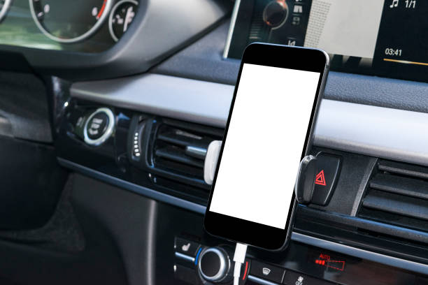 istock Smartphone in a car use for Navigate or GPS. Driving a car with Smartphone in holder. Mobile phone with isolatede white screen. Blank empty screen. copy space. Empty space for text. modern car interior details. 843550748
