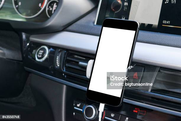 Smartphone In A Car Use For Navigate Or Gps Driving A Car With Smartphone In Holder Mobile Phone With Isolatede White Screen Blank Empty Screen Copy Space Empty Space For Text Modern Car Interior Details Stock Photo - Download Image Now