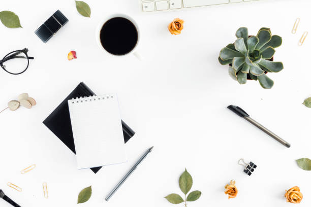 istock Home office workspace. Feminine workplace with keyboard, notepad, succulents, pen and cup of coffee. Office table desk. Top view 843554486