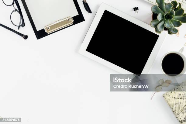 White Tablet With Clipboard Keyboard Notepad Glasses Succulents And Cup Of Coffee Office Table Desk Top View Stock Photo - Download Image Now