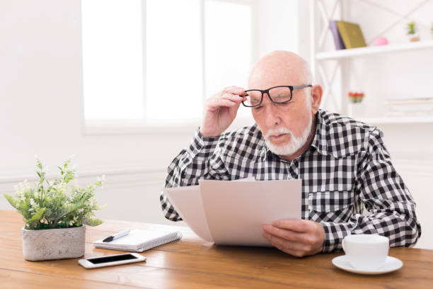istock Shocked senior man looking at bills copy space 843564548