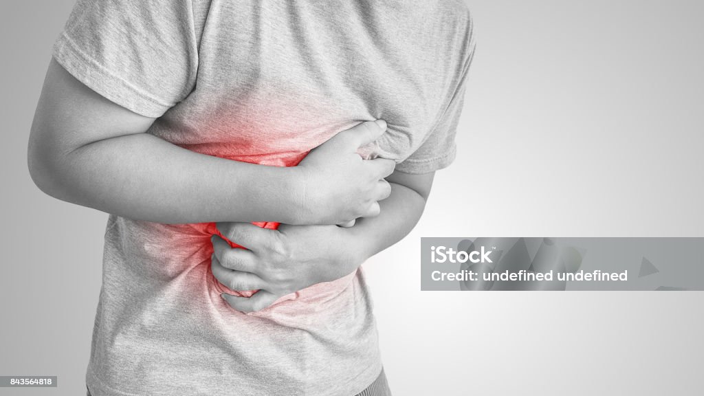asian man suffering from stomachache. asian man suffering from stomachache, black and white Gastroesophageal Reflux Disease Stock Photo