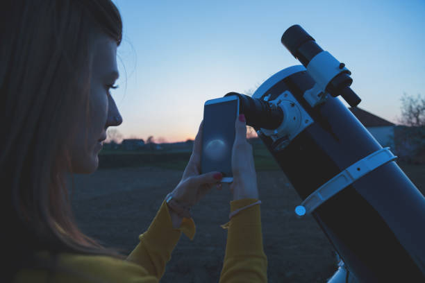 istock Photographing the Moon through a telescope with cellphone. 843564912