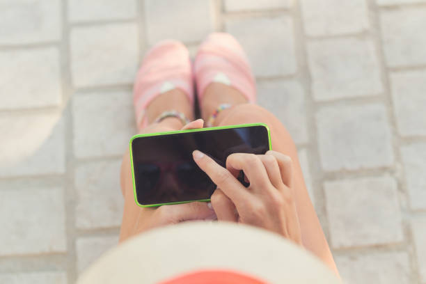 istock Girl texting while sitting on the bench outdoors. 843565364