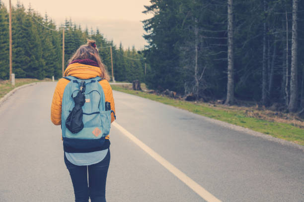 istock Girl walking down the empty suburb road. 843565610