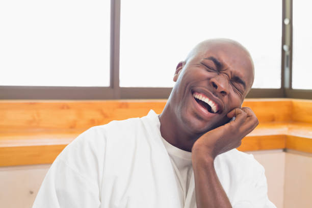 istock Laughing man in bathrobe talking on phone 843565884