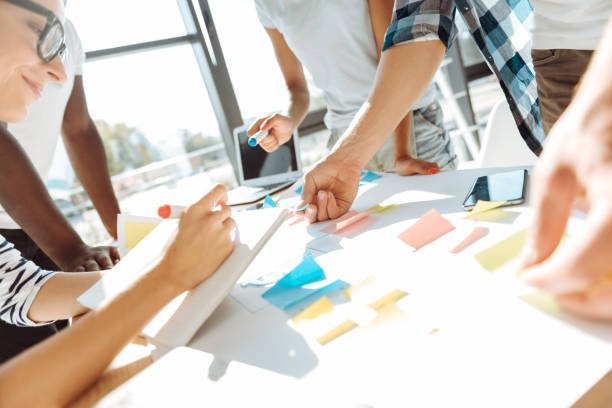 istock Close up of professional colleagues using sticky notes 843566066
