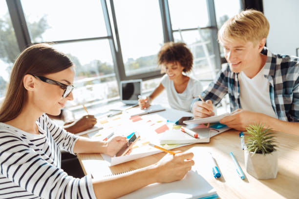 istock Cheerful woman sitting at the table with her colleagues 843566984