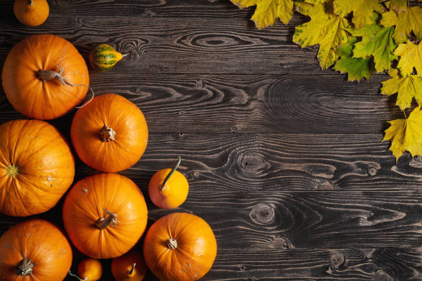 istock Ripe yellow pumpkins over wooden background 843567054