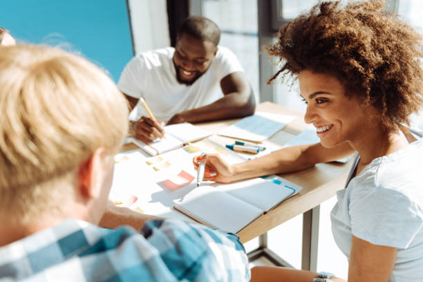 istock Psitive female afro american student studying with her groupmates 843567216
