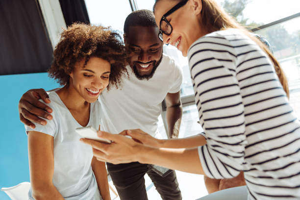 istock Cheerful international students uisng smart phone 843569774