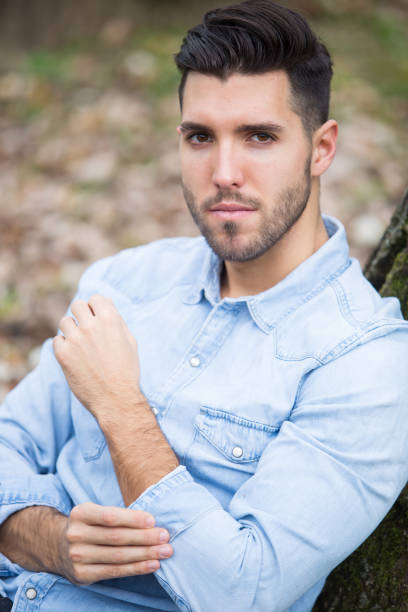 istock Handsome sad man in the park. Autumn scenery 843570066