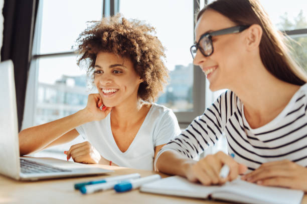 istock Positive female students enjoying distance learning 843570570