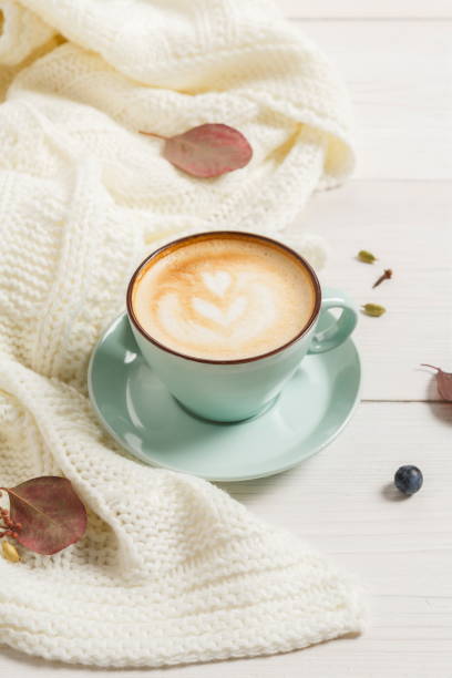 istock Autumn cappuccino coffee cup on white wood background 843572872