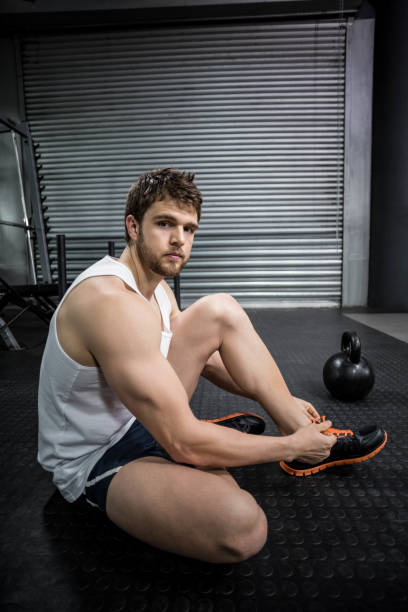 istock Fit man tying his shoelaces 843573750