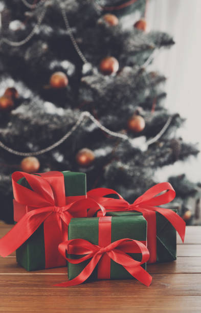 istock Christmas gifts on decorated tree background, holiday concept 843574250