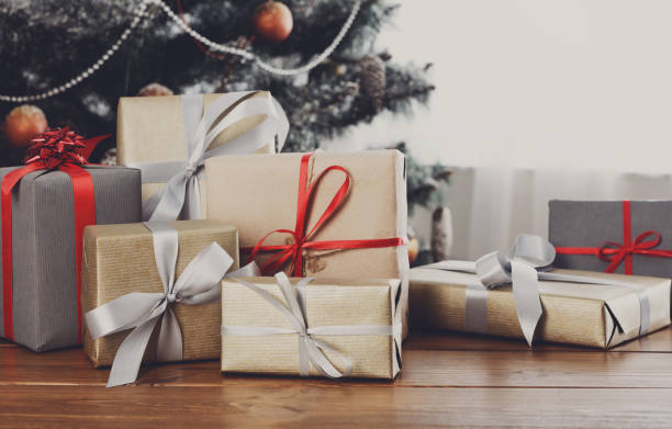 istock Christmas gifts on decorated tree background, holiday concept 843574434