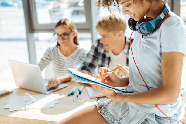 istock Cheerful afro american woman studying with her groupmates 843574568