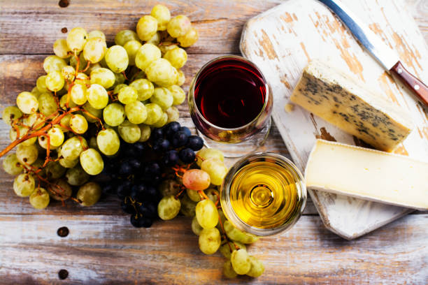 istock Red and white wine and assortment of cheese 843581120