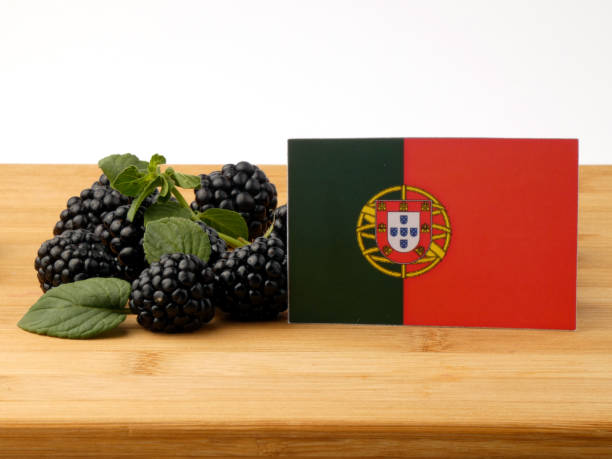 Portuguese flag on a wooden panel with blackberries isolated on a white background