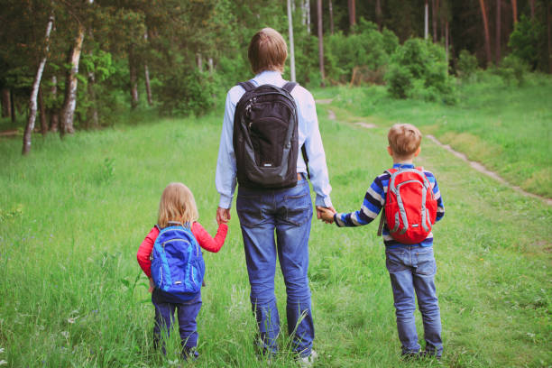istock father taking kids to school or daycare 843581706