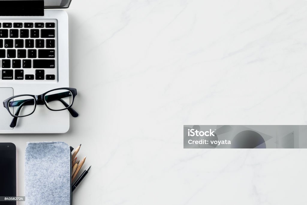 Top view of modern office marble desktop background Business concept - Top view of modern office marble desktop background with blank notebook, pencil for mockup design and copy space Desk Stock Photo