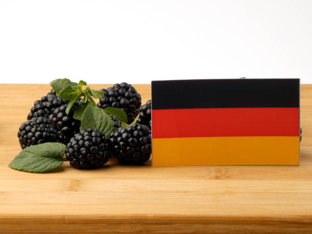 istock German flag on a wooden panel with blackberries isolated on a white background 843583150