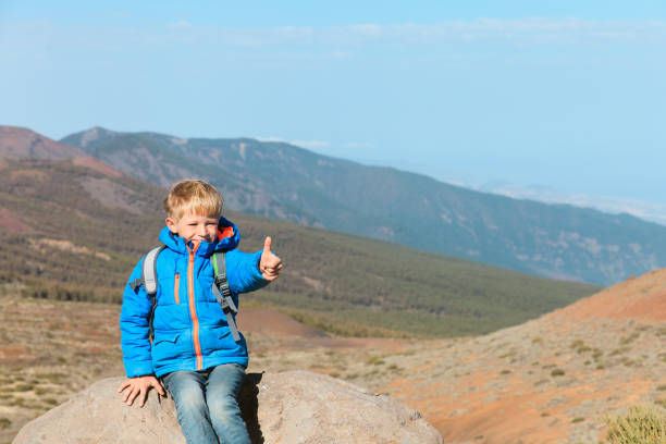 istock little boy with thumb up enjoy hiking in mountains 843585896
