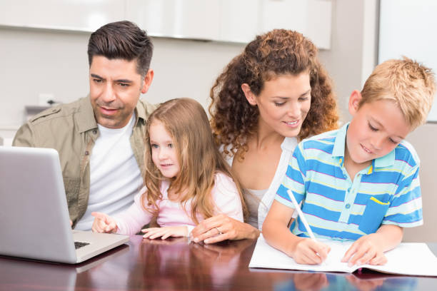 istock Cheerful parents colouring and using laptop with their children 843586474