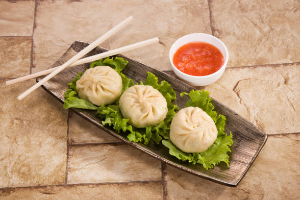 istock Traditional Dumpling Momos Served With Tomato Sauce 843587098