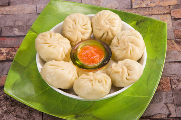 istock Traditional Dumpling Momos Served With Tomato Sauce 843587202