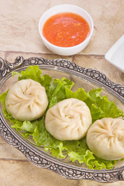 istock Traditional Dumpling Momos Served With Tomato Sauce 843587222