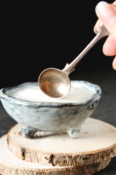 istock Homemade sour cream in a ceramic bowl. Dark background. 843590188